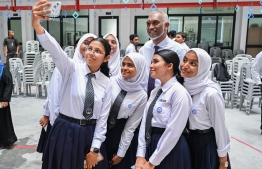 Students of Centre for Higher Secondary Education (CHSE) taking selfies with President Dr Mohamed Muizzu upon his arrival to the special assembly held at the school to commemorate their 45th anniversary. -- Photo: President's Office