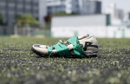 A damaged shoe discarded on a Turf Ground. A court ruling was also passed against FAM over their negligence in settling waste disposal fees to WAMCO. -- Photo: Nishan Ali / Mihaaru News