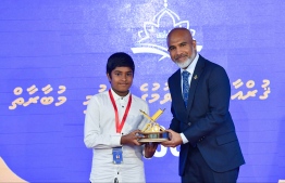 Education Minister Shafeeu presents an award at the closing ceremony of the 36th National Quran Competition.-- Photo: President's Office