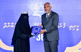 President Dr Mohamed Muizzu presents an award at the closing ceremony of the 36th National Quran Competition.-- Photo: President's Office