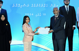 President Dr Mohamed Muizzu presents scholarship awarding letter.-- Photo: Nishan Ali / Mihaaru