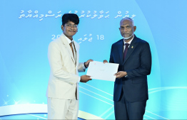 President Dr Mohamed Muizzu presents scholarship awarding letter.-- Photo: Nishan Ali / Mihaaru