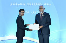 President Dr Mohamed Muizzu presents scholarship awarding letter.-- Photo: Nishan Ali / Mihaaru