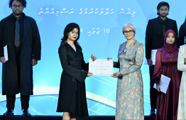 Minister of Higher Education, Labour and Skills Development Dr Maryam Mariya presents scholarship awarding letter.-- Photo: Nishan Ali / Mihaaru