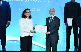 Minister of Education Dr Ismail Shafeeu presents scholarship awarding letter.-- Photo: Nishan Ali / Mihaaru