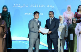 Minister of Health Dr Abdulla Khaleel presents scholarship awarding letter.-- Photo: Nishan Ali / Mihaaru