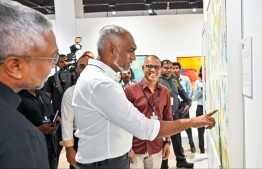 President Dr Mohamed Muizzu viewing the artwork of local artists featured at the art exhibition 'Unveiling Visions 2024'. -- Photo: Fayaz Moosa / Mihaaru News