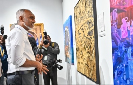 President Dr Mohamed Muizzu viewing the artwork of local artists featured at the art exhibition 'Unveiling Visions 2024'. -- Photo: Fayaz Moosa / Mihaaru News