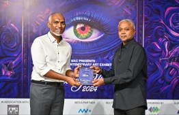 President Dr Mohamed Muizzu delivered a book upon his arrival at the art exhibition 'Unveiling Visions 2024' to see the featured artworks of local artists. -- Photo: Fayaz Moosa / Mihaaru News