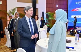 Minister of Social and Family Development Dr Aishath Shiham deliberating with an attendee at the opening ceremony of the 11th edition of the Maldives Finance Forum held on Monday. -- Photo: Nishan Ali / Mihaaru News