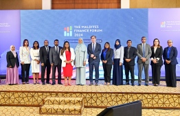 Chairperson of the Maldives Pension Administration Office (MPAO) Dr Ahmed Inaz and Minister of Social and Family Development Dr Aishath Shiham posing for a photo with participants of the 11th edition of the Maldives Finance Forum held on Monday. -- Photo: Nishan Ali / Mihaaru News