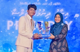 First Lady Sajidha Mohamed presenting awards to a student who ranked first in their academics at the  Centre for Higher Secondary Education's (CHSE) during the school's annual Prize Day ceremony held on Monday night. -- Photo: President's Office