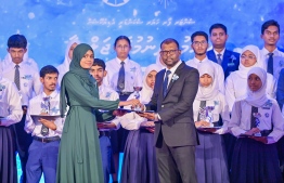 A student who secured a top rank in their academics at the Centre for Higher Secondary Education's (CHSE) receiving their award at the school's annual Prize Day ceremony held on Monday night. -- Photo: President's Office