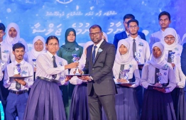 A student who secured a top rank in their academics at the Centre for Higher Secondary Education's (CHSE) receiving their award at the school's annual Prize Day ceremony held on Monday night. -- Photo: President's Office