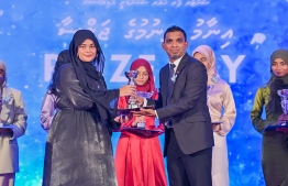 A student who secured a top rank in their academics at the Centre for Higher Secondary Education's (CHSE) receiving their award at the school's annual Prize Day ceremony held on Monday night. -- Photo: President's Office