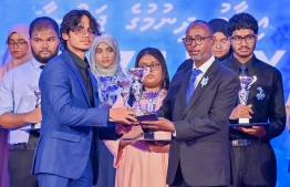 A student who secured a top rank in their academics at the Centre for Higher Secondary Education's (CHSE) receiving their award at the school's annual Prize Day ceremony held on Monday night. -- Photo: President's Office