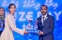 A student who secured a top rank in their academics at the Centre for Higher Secondary Education's (CHSE) receiving their award at the school's annual Prize Day ceremony held on Monday night. -- Photo: President's Office