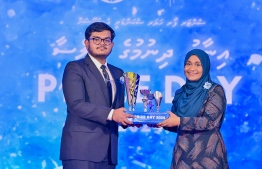 First Lady Sajidha Mohamed presenting awards to a student who secured a top rank in their academics at the Centre for Higher Secondary Education's (CHSE) during the school's annual Prize Day ceremony held on Monday night. -- Photo: President's Office