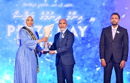 Minister of Education Dr. Ismail Shafeeu presenting awards to a student who secured a top rank in their academics at the Centre for Higher Secondary Education's (CHSE) during the school's annual Prize Day ceremony held on Monday night. -- Photo: President's Office