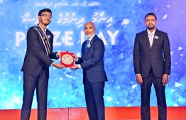 Minister of Education Dr. Ismail Shafeeu presenting awards to a student who secured a top rank in their academics at the Centre for Higher Secondary Education's (CHSE) during the school's annual Prize Day ceremony held on Monday night. -- Photo: President's Office