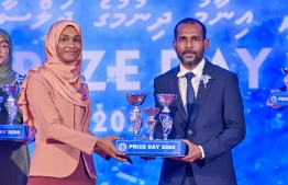 A student who secured a top rank in their academics at the Centre for Higher Secondary Education's (CHSE) receiving their award at the school's annual Prize Day ceremony held on Monday night. -- Photo: President's Office