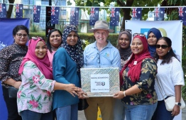 High Commissioner Jessup at Australian High Commission’s community event Sausage Sizzle, accepting books donated by Maldives Women in Policing -- Photo Credits: Australia High Commission