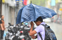 A child walking on the streets with an umbrella during heavy rain in Male' City; Haa Alif atoll Kelaa had recorded the highest rainfall across the island nation within 24 hours. -- Photo: Nishan Ali / Mihaaru News