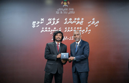 President Dr Mohamed Muizzu awarding the offer letter to a member of the Maldivian Youth Advisory Committee established to provide counsel to the President in various areas. -- Photo: President's Office