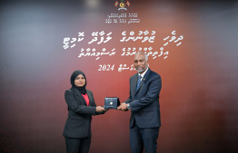 President Dr Mohamed Muizzu awarding the offer letter to a member of the Maldivian Youth Advisory Committee established to provide counsel to the President in various areas. -- Photo: President's Office