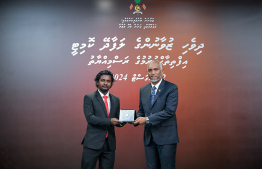 President Dr Mohamed Muizzu awarding the offer letter to a member of the Maldivian Youth Advisory Committee established to provide counsel to the President in various areas. -- Photo: President's Office