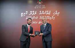 President Dr Mohamed Muizzu awarding the offer letter to a member of the Maldivian Youth Advisory Committee established to provide counsel to the President in various areas. -- Photo: President's Office