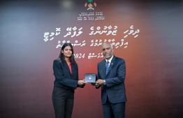 President Dr Mohamed Muizzu awarding the offer letter to a member of the Maldivian Youth Advisory Committee established to provide counsel to the President in various areas. -- Photo: President's Office