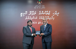 President Dr Mohamed Muizzu awarding the offer letter to a member of the Maldivian Youth Advisory Committee established to provide counsel to the President in various areas. -- Photo: President's Office