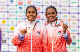 [File] Fathimath Ibrahim (L) and her guide runner posing for a photo with their medal during the Indian Ocean Island Games 2023. -- Photo: Ismail Thoriq / MOC