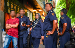 An expatriate working unlawfully at a hotel in capital Male' being brought into Immigration custody during yesterday's operations. -- Photo: Fayaz Moosa / Mihaaru News