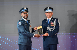 Police Commissioner, Ali Shujau awarding the plaque of memorandum to a police officer in recognition of service in the line of duty for over 25 years. -- Photo: Nishan Ali / Mihaaru News