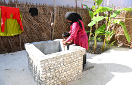 A child bathing near a well built in the 'Traditional Dhivehi Land' in Maafushi Prison. -- Photo: President's Office