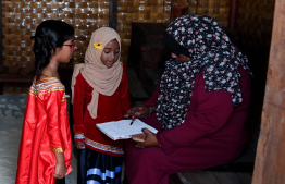 Edhuru Dhaitha teaching children in a home built in the 'Traditional Dhivehi Land' in Maafushi Prison. -- Photo: President's Office