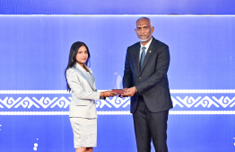 President Dr Mohamed Muizzu presenting an award to a student at the High Achievers Award Ceremony 2022-2023 held today. -- Photo: Nishan Ali / Mihaaru News