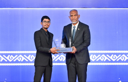 President Dr Mohamed Muizzu presenting an award to a student at the High Achievers Award Ceremony 2022-2023 held today. -- Photo: Nishan Ali / Mihaaru News