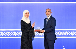 Minister of Education Dr Ismail Shafeeu presenting an award to a student at the High Achievers Award Ceremony 2022-2023 held today. -- Photo: Nishan Ali / Mihaaru News