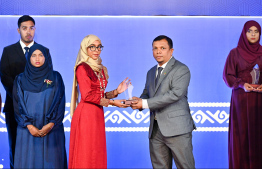 Minister of Finance Dr Mohamed Shafeeq presenting an award to a student at the High Achievers Award Ceremony 2022-2023 today. -- Photo: Nishan Ali / Mihaaru News