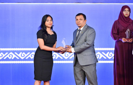 Minister of Finance Dr Mohamed Shafeeq presenting an award to a student at the High Achievers Award Ceremony 2022-2023 today. -- Photo: Nishan Ali / Mihaaru News