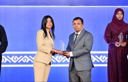 Minister of Finance Dr Mohamed Shafeeq presenting an award to a student at the High Achievers Award Ceremony 2022-2023 today. -- Photo: Nishan Ali / Mihaaru News