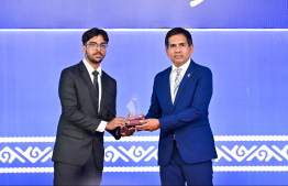 Minister of Economic Development and Trade Mohamed Saeed presenting an award to a student at the High Achievers Award Ceremony 2022-2023 today. -- Photo: Nishan Ali / Mihaaru News