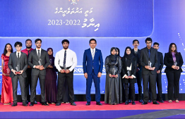 Minister of Economic Development and Trade Mohamed Saeed posing with student for a photo at the High Achievers Award Ceremony 2022-2023 today. -- Photo: Nishan Ali / Mihaaru News