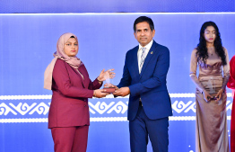 Minister of Economic Development and Trade Mohamed Saeed presenting an award to a student at the High Achievers Award Ceremony 2022-2023 today. -- Photo: Nishan Ali / Mihaaru News