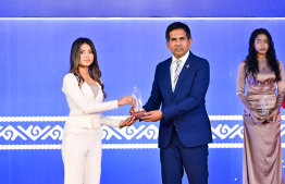 Minister of Economic Development and Trade Mohamed Saeed presenting an award to a student at the High Achievers Award Ceremony 2022-2023 today. -- Photo: Nishan Ali / Mihaaru News