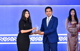 Minister of Economic Development and Trade Mohamed Saeed presenting an award to a student at the High Achievers Award Ceremony 2022-2023 today. -- Photo: Nishan Ali / Mihaaru News