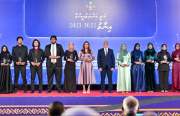 Minister of Housing, Land and Urban Development Ali Haidar Ahmed posing with student for a photo at the High Achievers Award Ceremony 2022-2023 today. -- Photo: Nishan Ali / Mihaaru News